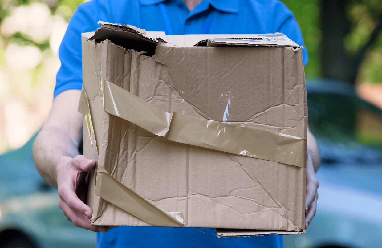 A deliveryman carrying a damaged parcel