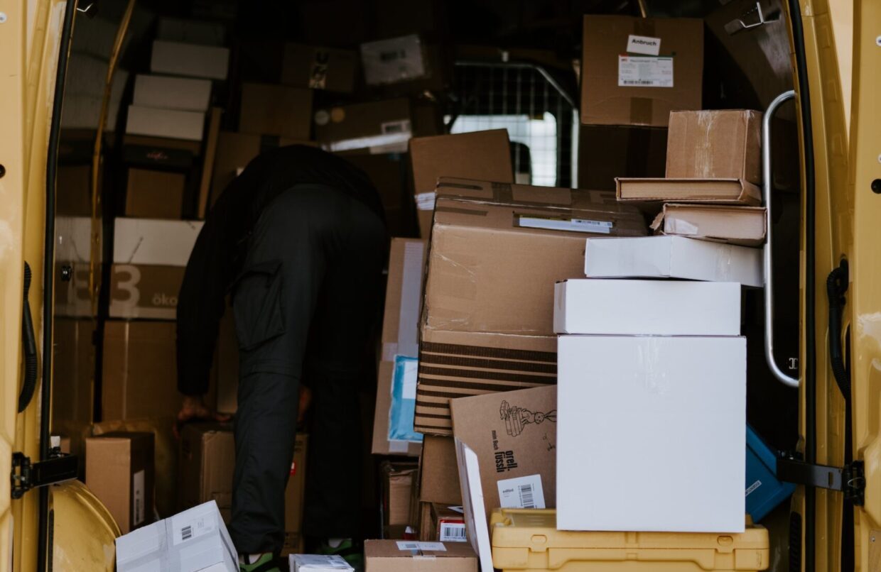 Packages piled in delivery van after peak season shipping delays