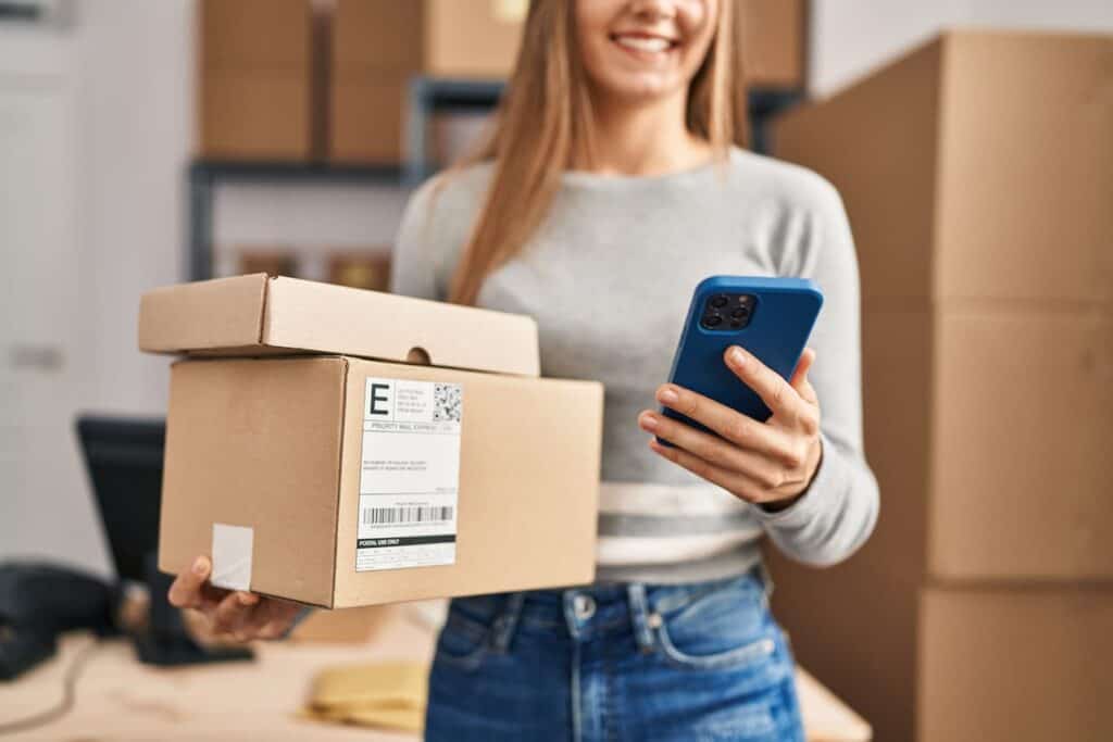 Woman using phone for parcel tracking delivery