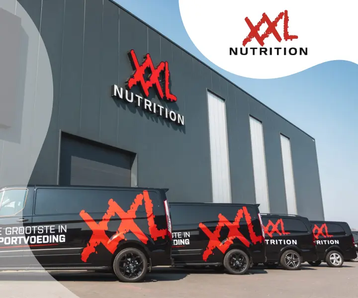 Exterior of XXL Nutrition building with branded delivery vans parked in front